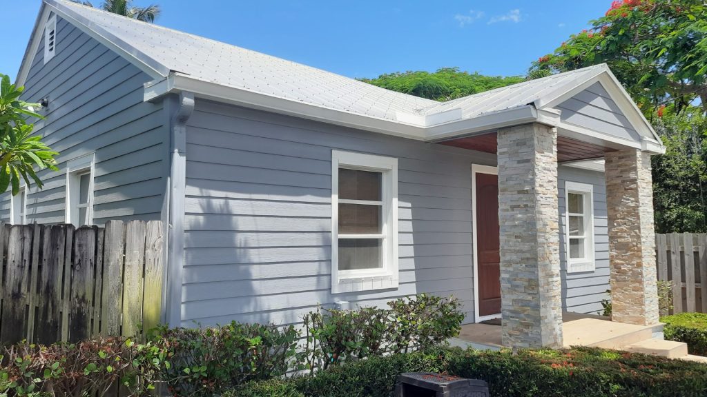 Exterior home improvement with updated siding, trim, and front entry