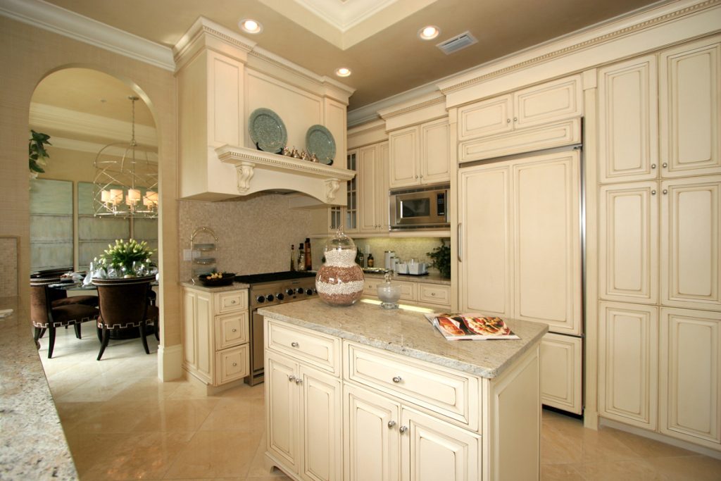Kitchen remodeling with custom cabinets, island storage, and stone countertops