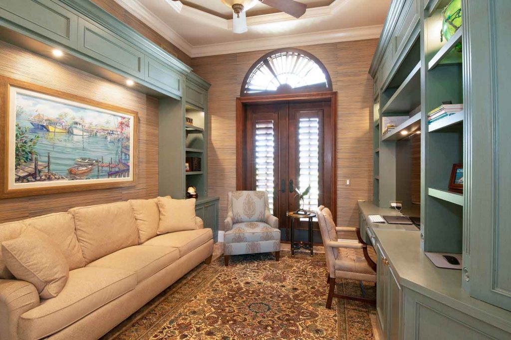 Home office with built in cabinetry, shelving, and finish carpentry